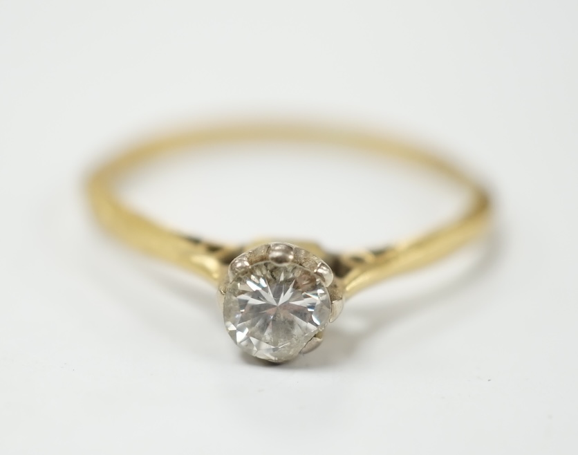 A modern 18tc gold and solitaire diamond set ring, size K, gross weight 1.4 grams. Condition -fair